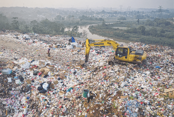 landfill site with yellow digger