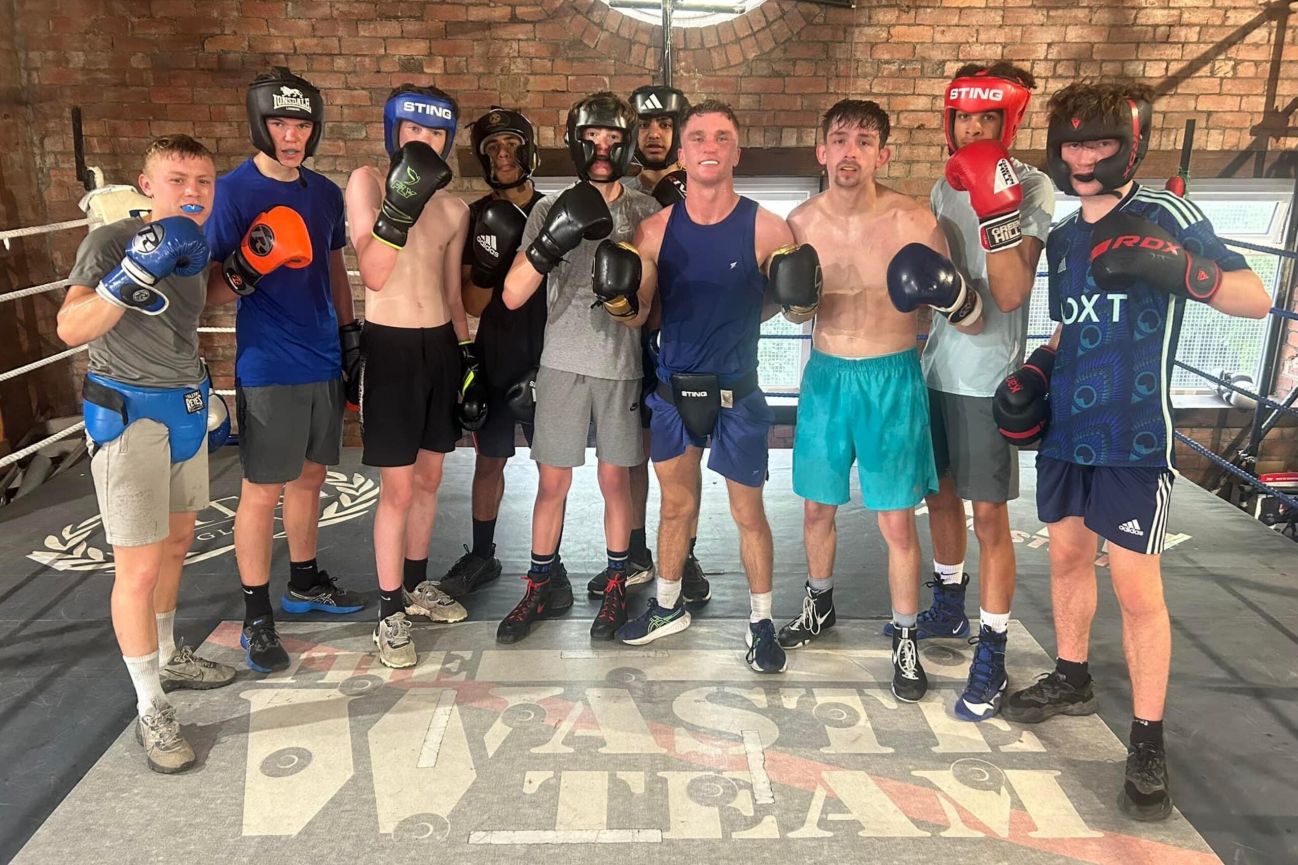 Amateur boxers posing in a gym