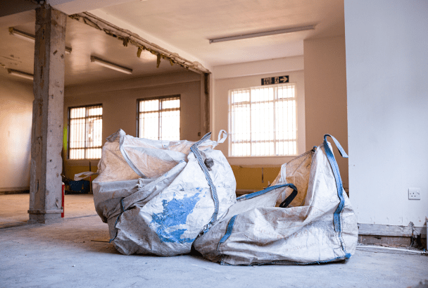 2 commercial waste bags half full with waste from asbestos removal in a large building
