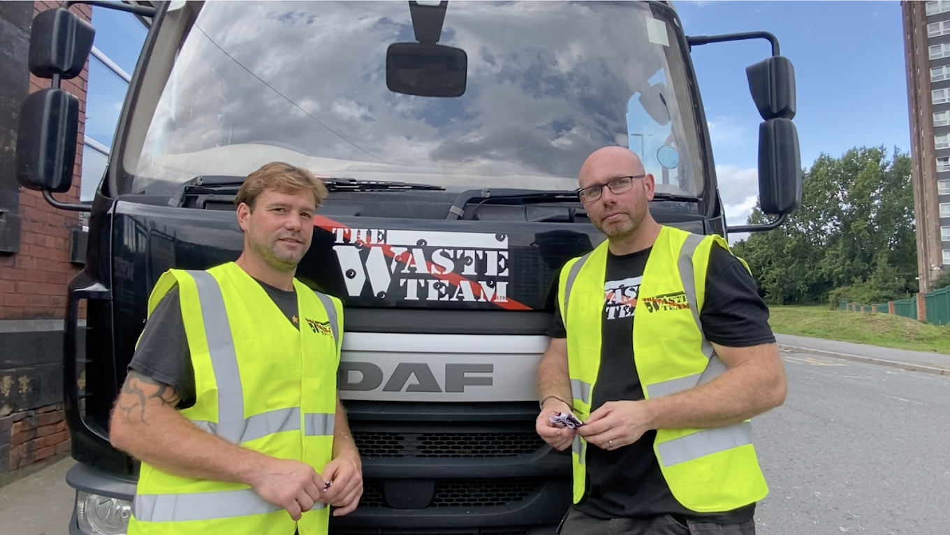 Oliver and Dan from waste team leaning against a van