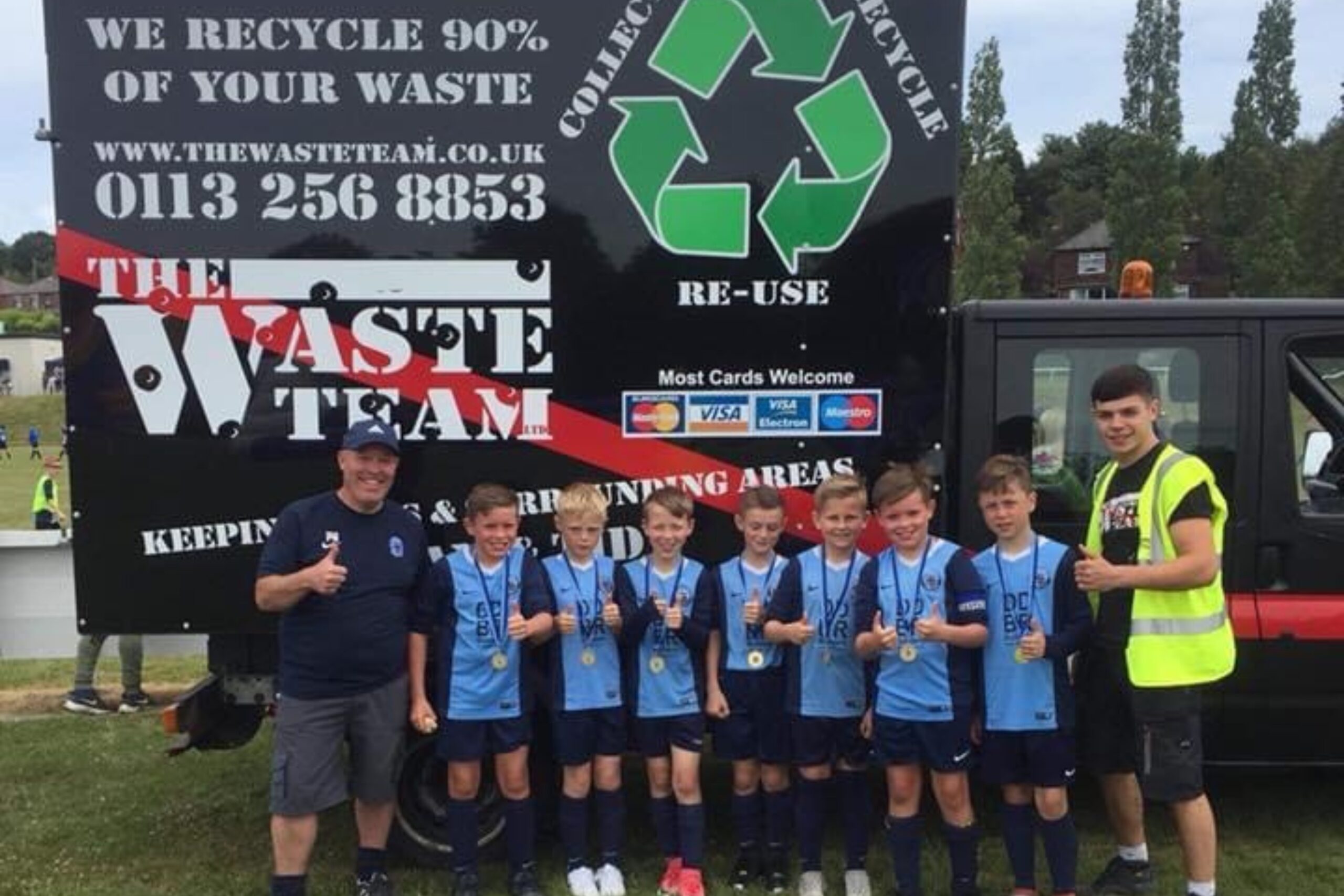 Wortley Football club boys team standing beside Waste Team banner