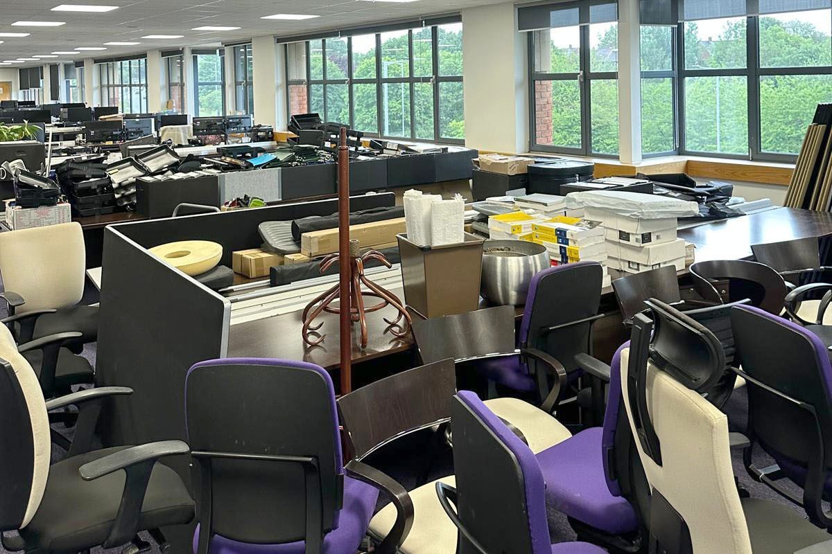 Office clearance, lots of desks, miscellaneous items and chairs ready to be sorted and cleared by the waste team