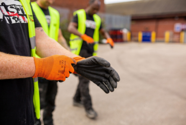 Man putting on gloves ready to clear waste