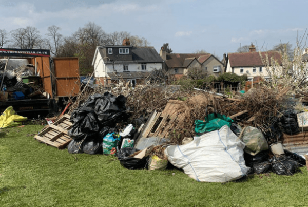 various waste piled up in a large stack on a lawned area